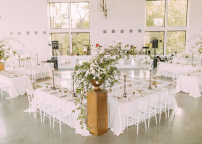 Tables set up at wedding with place settings and flowers